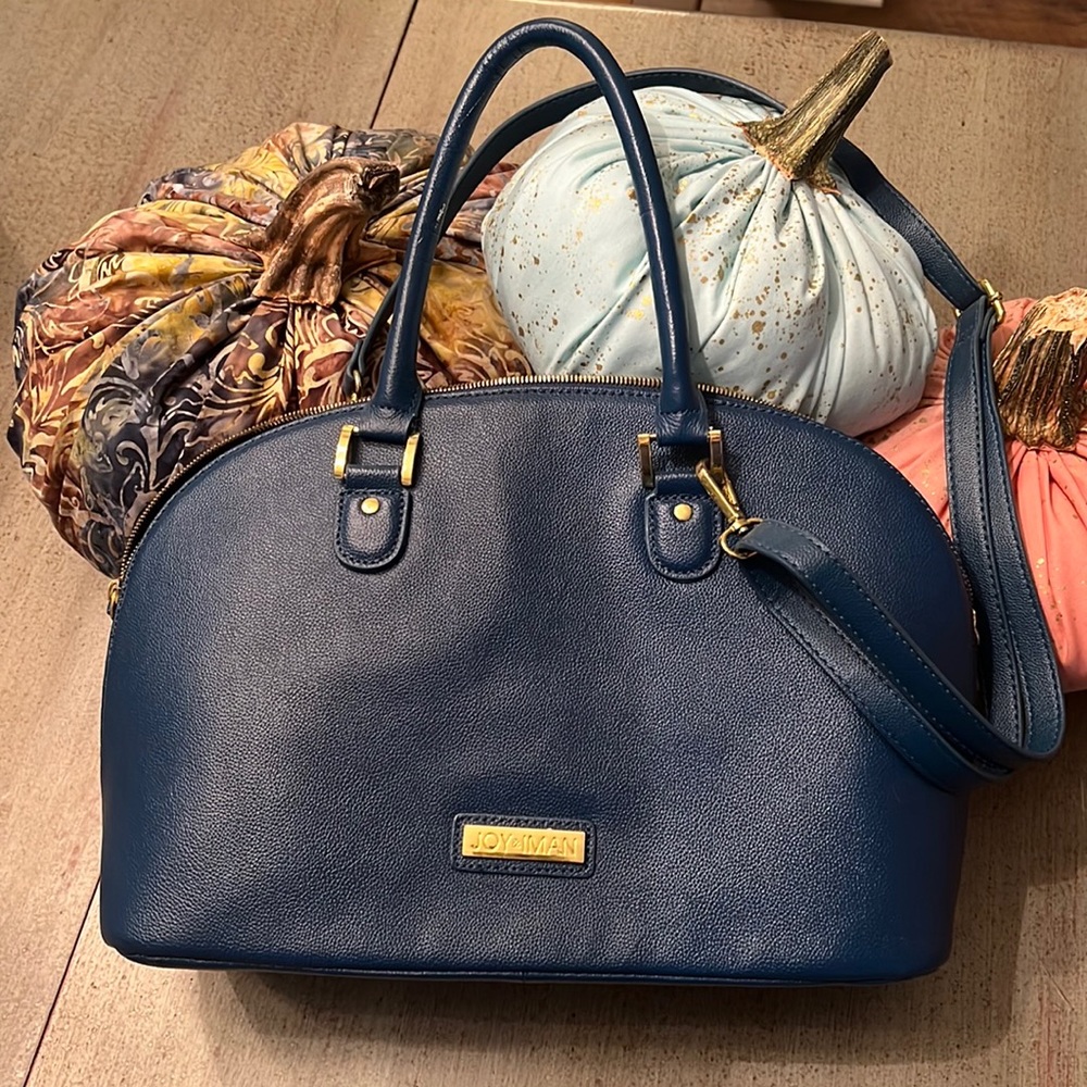 Light weight medium blue pebble leather with shoulder strap.